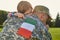Italian soldier is hugging his little daughter.
