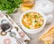 Italian soup with orzo pasta. Chicken orzo soup in a white crock, bowl on wooden background