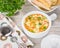 Italian soup with orzo pasta. Chicken orzo soup in a white crock on wooden background