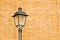 Italian streetlight of nineteenth century against a brick wall - Image with copy space