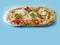 Italian style uncooked pizza on blue color background. Premium product with high quality ingredients