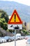 Italian temporary warning sign `Other danger` with additional panel `Construction vehicles at work`