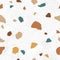 Italian terrazzo seamless pattern. Trendy endless texture design with repeatable scattered stone fragments of organic