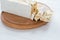 Italian torrone or nougat with almonds on a white wooden table, close up with selected focus