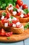 Italian traditional bruschetta with tomatoes and cheese close-up.