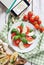 Italian traditional Caprese salad with traveler smartphone map t