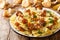 Italian traditional ravioli with fried mushrooms and parmesan cheese closeup on a plate. horizontal