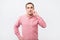 Italian young man in pink shirt doing a silence gesture