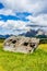 Italy, Alpe di Siusi, Seiser Alm with Sassolungo Langkofel Dolomite, an old barn in a field demolished