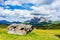 Italy, Alpe di Siusi, Seiser Alm with Sassolungo Langkofel Dolomite, an old barn in a field demolished