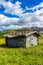 Italy, Alpe di Siusi, Seiser Alm with Sassolungo Langkofel Dolomite, an old barn in a fieldItaly, Alpe di Siusi, Seiser Alm with