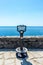 Italy, Cinque Terre, Vernazza, a tourist binocular vision looking out into the ocean with a boat