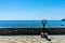 Italy, Cinque Terre, Vernazza, a tourist binocular vision looking out into the ocean with a boat