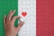 Italy flag is depicted on a puzzle, which the man`s hand completes to fold