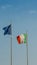 Italy flag and Europe flag waving together on a mast in isolated the blue sky background. Concept for financial treated