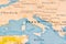 Italy in Focus on a Tilted World Map.