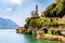 Italy, Lake Lugano. View of the lake, mountains and old houses and church, standing above the lake.