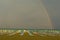 Italy, Lignano Beach with sunloungers, rainbow in background