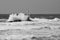 Italy, `Mangiabarche`, Storm. Waves smash against lighthouse or beacon.