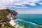 Italy May 2017 - view of Numana beach with crystal clear sea and limestone cliff