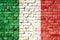 Italy national flag painted on a brick wall with the traditional green, white and red colors.