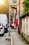 Italy, Novara. Two people are musical instruments in their cases. White and red.