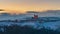 Italy Piedmont: panoramic winter snow view wine yards unique landscape at sunset, medieval castle and village on hill top, the