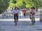 Italy relaxes lockdown to Phase Two. Two female teens biking in a park wearing protective masks Selective foreground focus