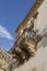 Italy, Sicily, Scicli Ragusa province, the Unesco Baroque Fava Palace facade 18th Century a.C., decoration under a balcony