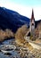Italy, Trentino Alto Adige, Bolzano, San Candido, view of the Aurino River with the small church dedicated to the Holy Spirit
