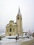 Italy, Trentino Alto Adige, Bolzano, San Vigilio di Marebbe, view of the church of the town during a winter day and during a snowf