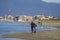 Italy Tuscany Maremma, on the beach towards Bocca di Ombrone, view of the coast line, in the background Marina di Grosseto and