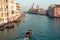 Italy, Venice 09 February 2019: boats are sailing in the grand canal of Venice during a sunny day with some gondolas at the end o