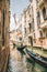 Italy, Venice - May 25, 2019: people at gondola taking tour by canal