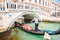 Italy, Venice - May 25, 2019: people at gondola taking tour by canal