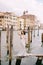 Italy wedding in Venice. The bride are standing on a wooden pier for boats and gondolas, near the Striped green and