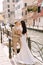 Italy wedding in Venice. Newlyweds stand embracing on the banks of the Venice Canal. The groom hugs the bride by the