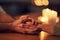 Itll be okay. Closeup of two unrecognizable people holding hands over a dinner table with candle light in the background