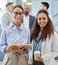 Its amazing how much we can achieve together. Portrait of two businesswomen standing in an office with their colleagues