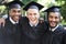 Its been tough, but weve finally made it. A group of happy male students on graduation day.