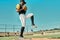 Its coming your way. shot of a young baseball player getting ready to pitch the ball during a game outdoors.