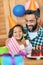 Its a day for feeling festive. a cute little girl celebrating her birthday with her parents at home.