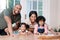 Its educational and fun for the whole family. Portrait of a happy family building a puzzle together at home.