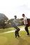 Its a gentlemans game. two young men shaking hands on a golf course.
