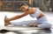 Its hard not to be happy when youre in good health. Portrait of a fit young woman stretching in a gym.