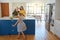 Its her favorite time of the day. a little girl dancing while her mother and grandmother cooks in the background.