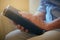 Its her pillar of strength. Closeup shot of a senior woman holding a Bible at home.