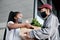 Its like bringing the store right to you. Shot of a masked young man delivering fresh produce to a customer at home.