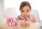 Its my birthday. a young girl blowing out the candles on her birthday cupcakes.