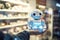With its quirky charm, the funny little robot zips through the supermarket, efficiently assisting with shopping. AI Generated